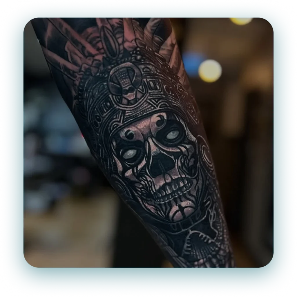 black-and-grey-realism-ancient-aztec-skull-arm-sleeve-tattoo